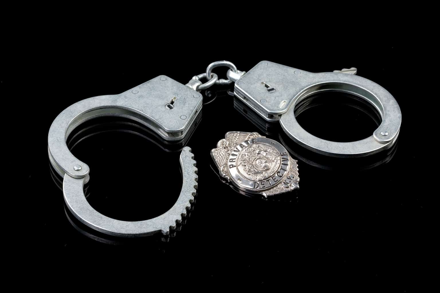 A pair of handcuffs with a badge