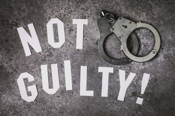 Handcuffs and the words "not guilty," possibly due to the Constitutional protections for double jeopardy 