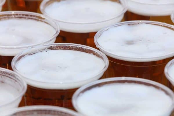 Multiple disposable cups holding beer to illustrate an article on hazing by a defense lawyer in Vista.