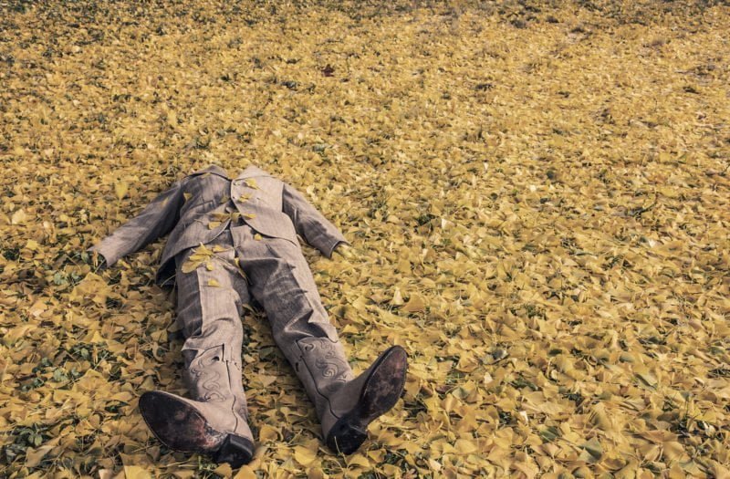 A suit on a pile of leaves that illustrates the issue of concealing an accidental death california