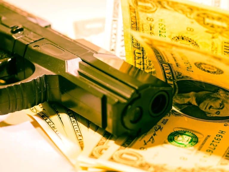 A gun on a pile of money