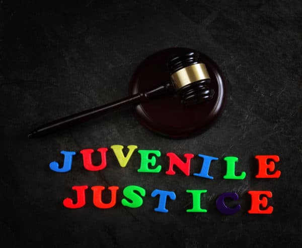 gavel and children's magnetic letters spelling "juvenile justice."