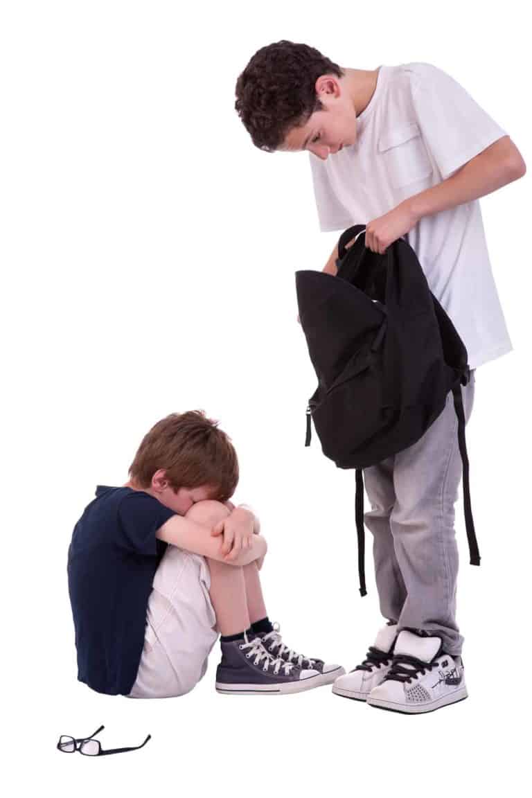 A young boy cries as a bully looks in his backpack.
