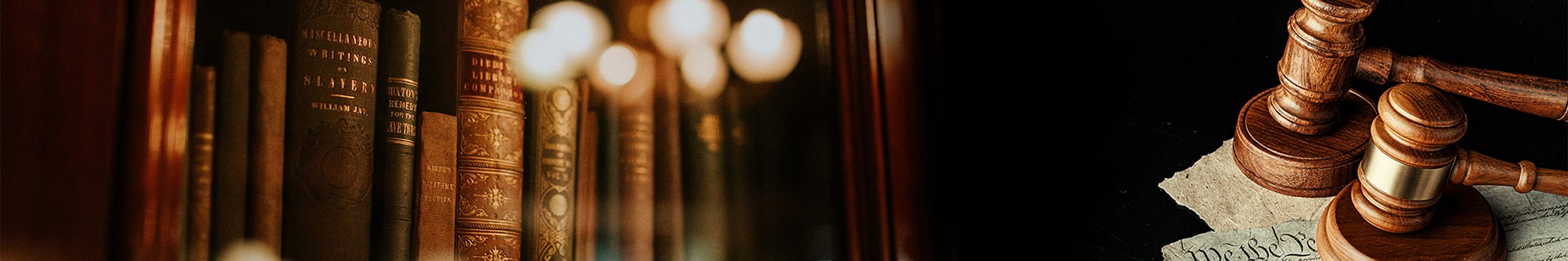 books and gavels used to illustrate article on how to hire a criminal defense lawyer near me