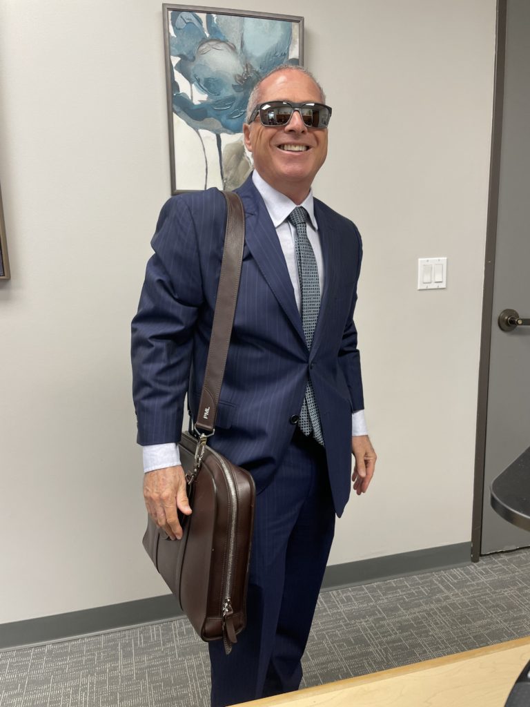 Vista Criminal Defense Attorney Peter Liss smiling at the camera in is San Diego office