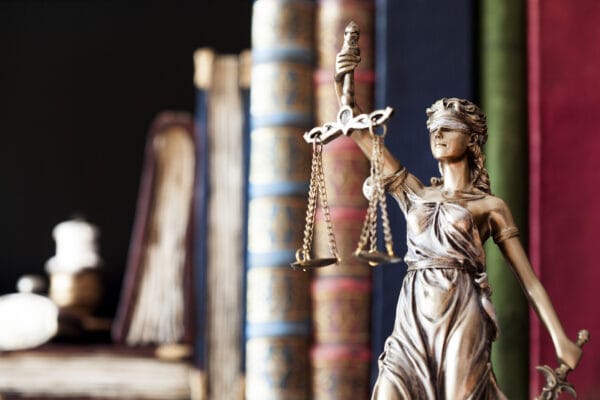 The scales of justice in front of books